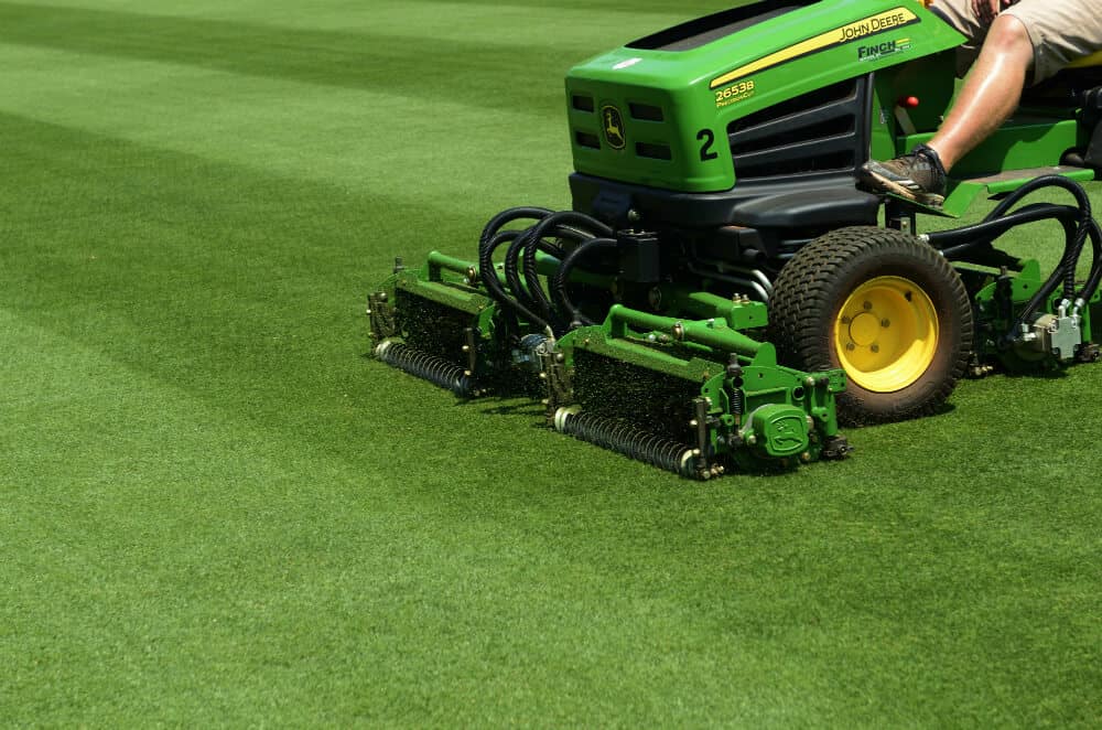 Ride on mower cutting grass